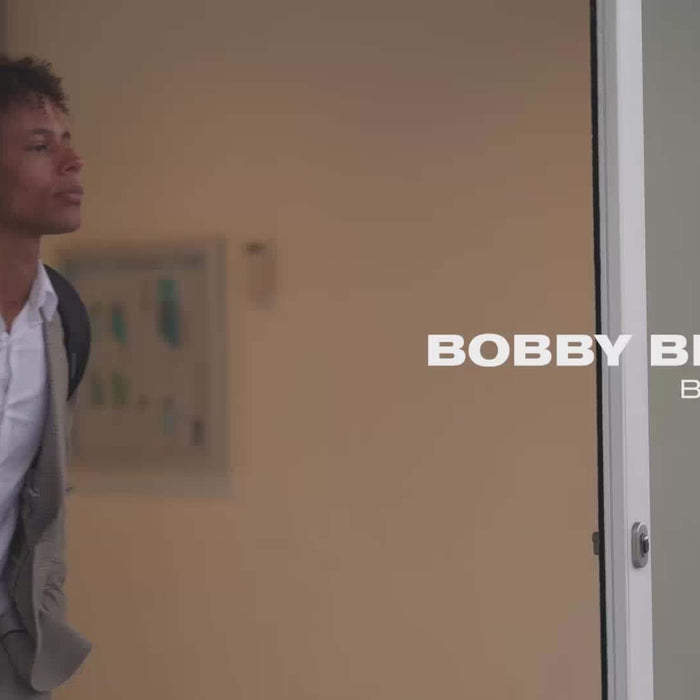 Man with Bobby Bizz 2.0 Anti-Theft Backpack, stylish and professional look for modern professionals.