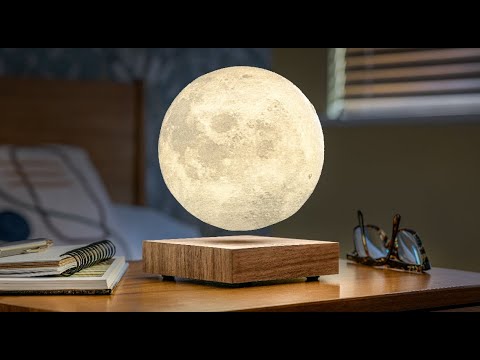 Smart Moon Lamp in walnut finish creating a serene ambiance on a bedside table, resembling the real moon.