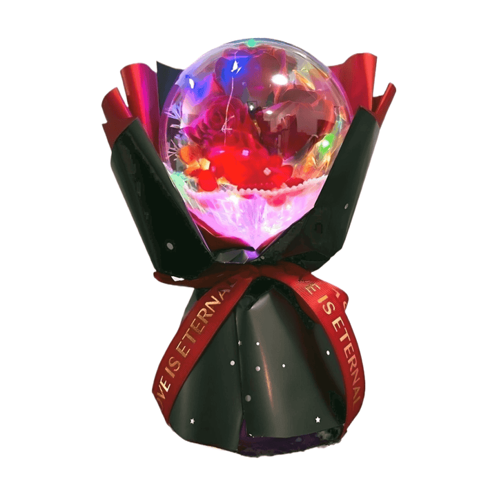 Red rose bouquet in acrylic dome with colorful LED lights, elegantly wrapped in black and red ribbon.