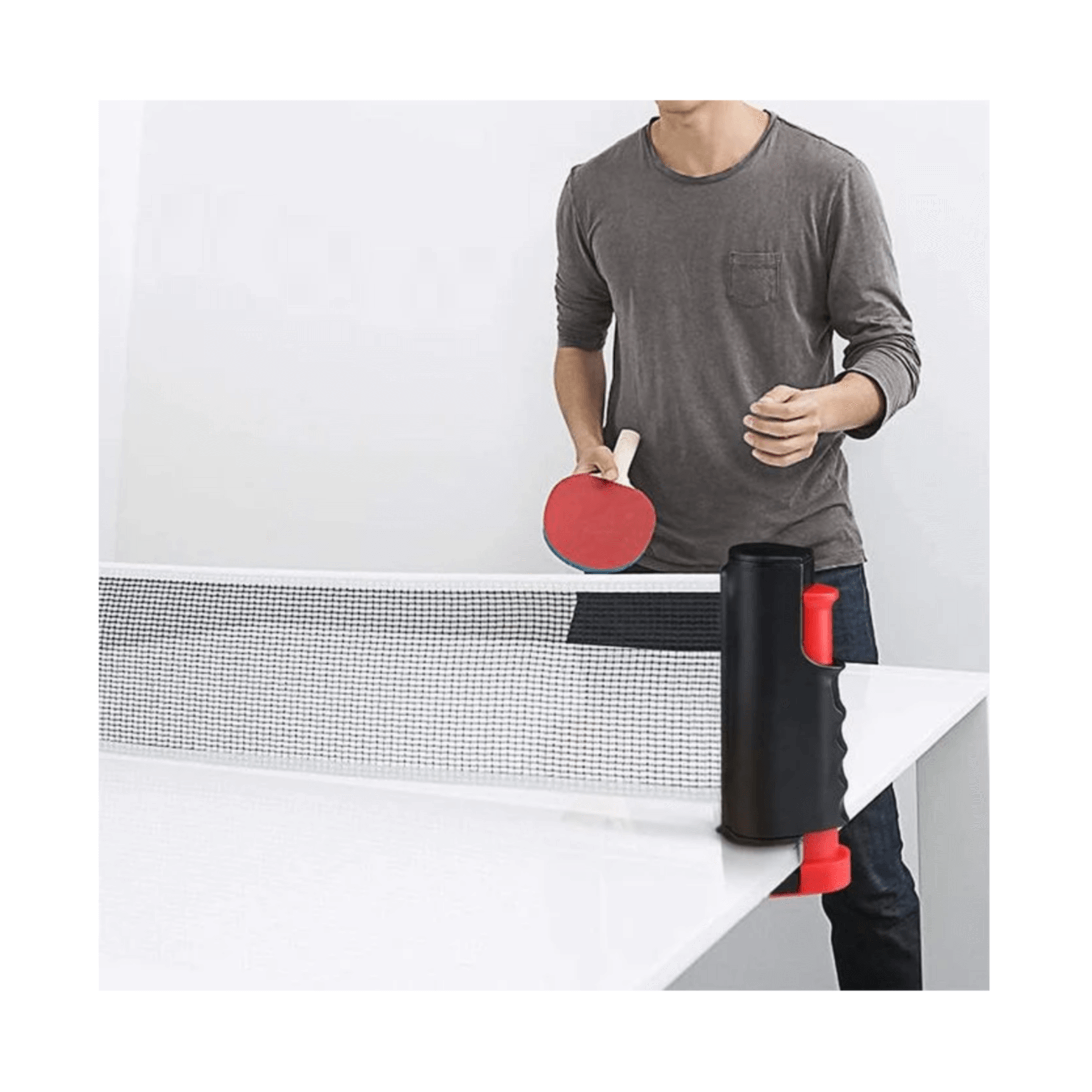 Person setting up a retractable tabletop ping pong net on a table for a game.