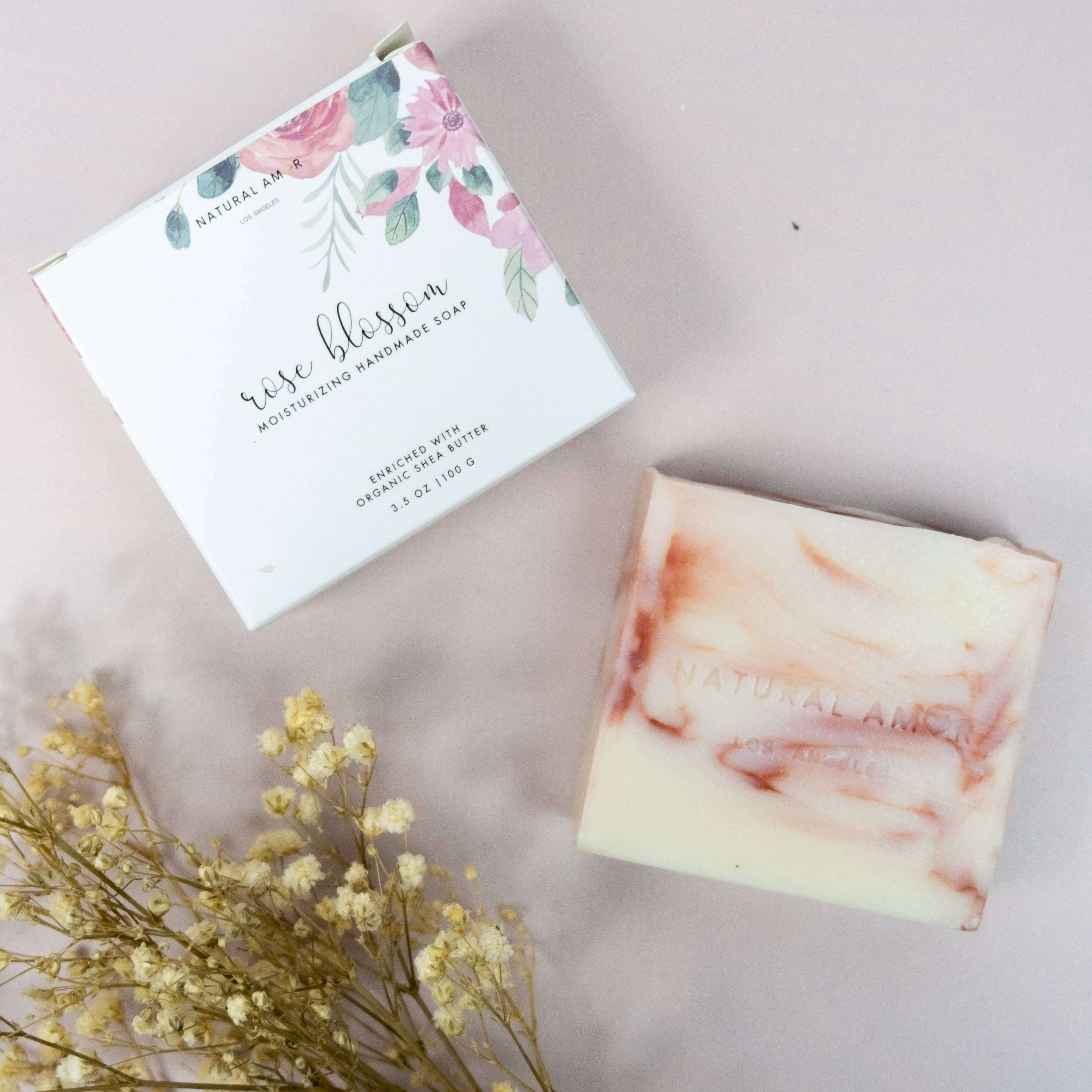 Handcrafted rose blossom moisturizing soap with floral packaging, ideal for natural spa gift sets.