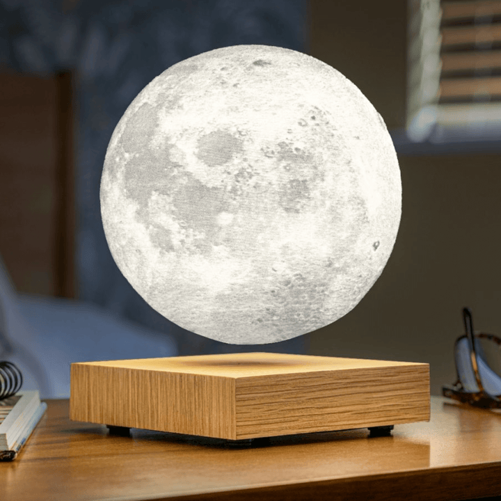 Smart Moon Lamp in walnut base, creating a cozy ambiance with a realistic lunar glow.