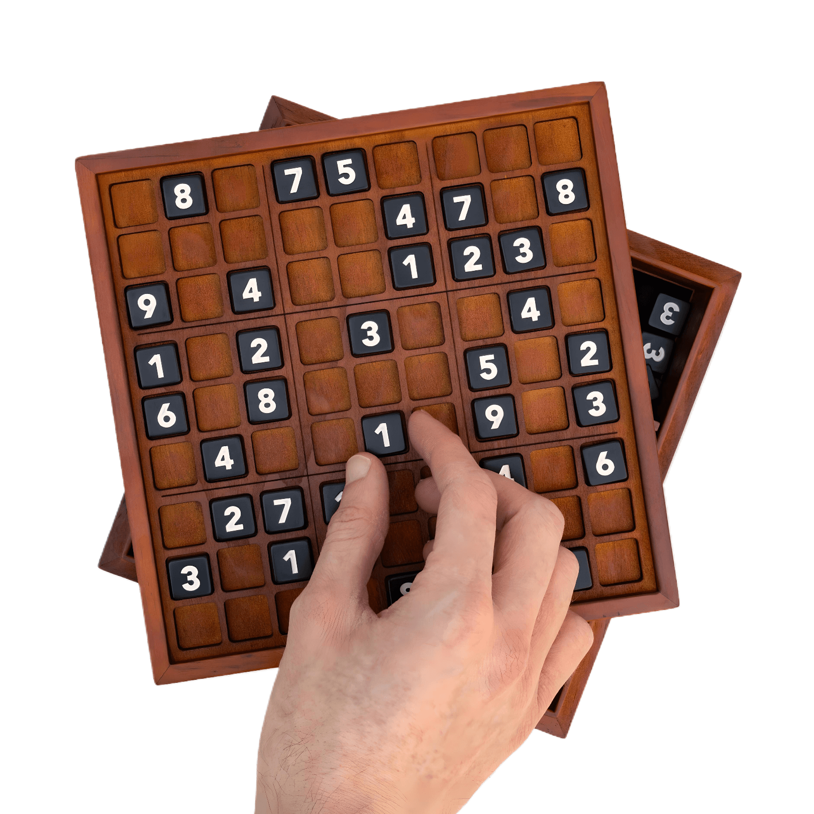 Hand placing numbers on an extra-large wooden Sudoku Deluxe XL board, featuring a classic number puzzle design.