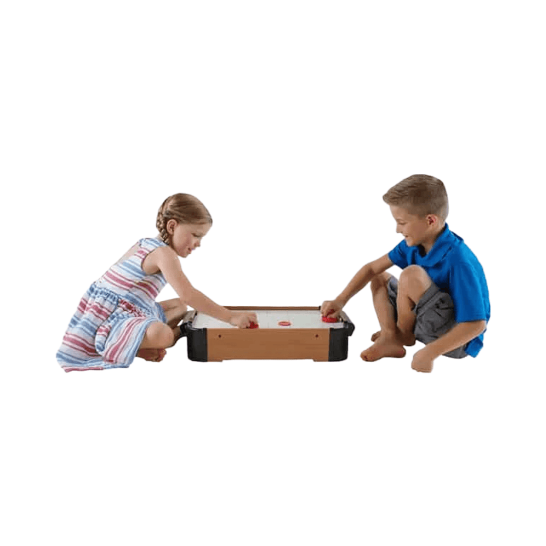 Tabletop Air Hockey Game being played by two children using red paddles on a compact wooden tabletop game set.