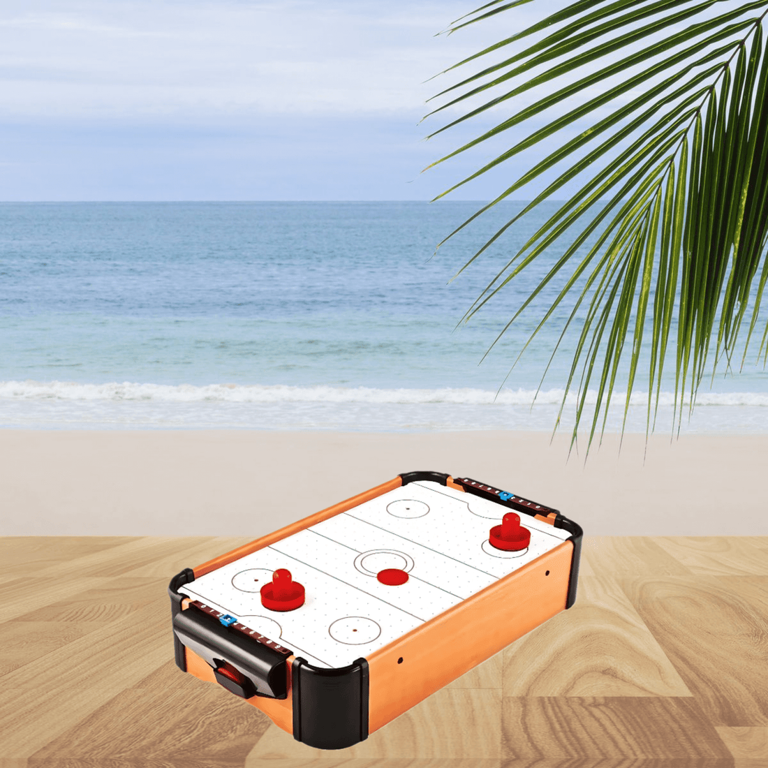 Tabletop Air Hockey Game with wooden frame, red paddles and puck displayed on a table with a beach background.