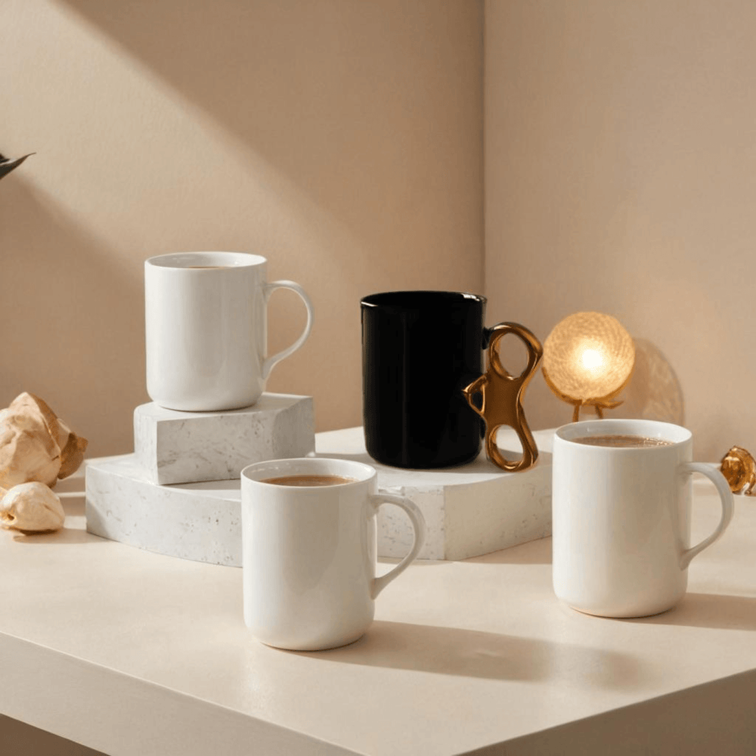 Wind-Up Mug Black with Gold handle alongside white mugs on a stylish table, showcasing modern ceramic designs.