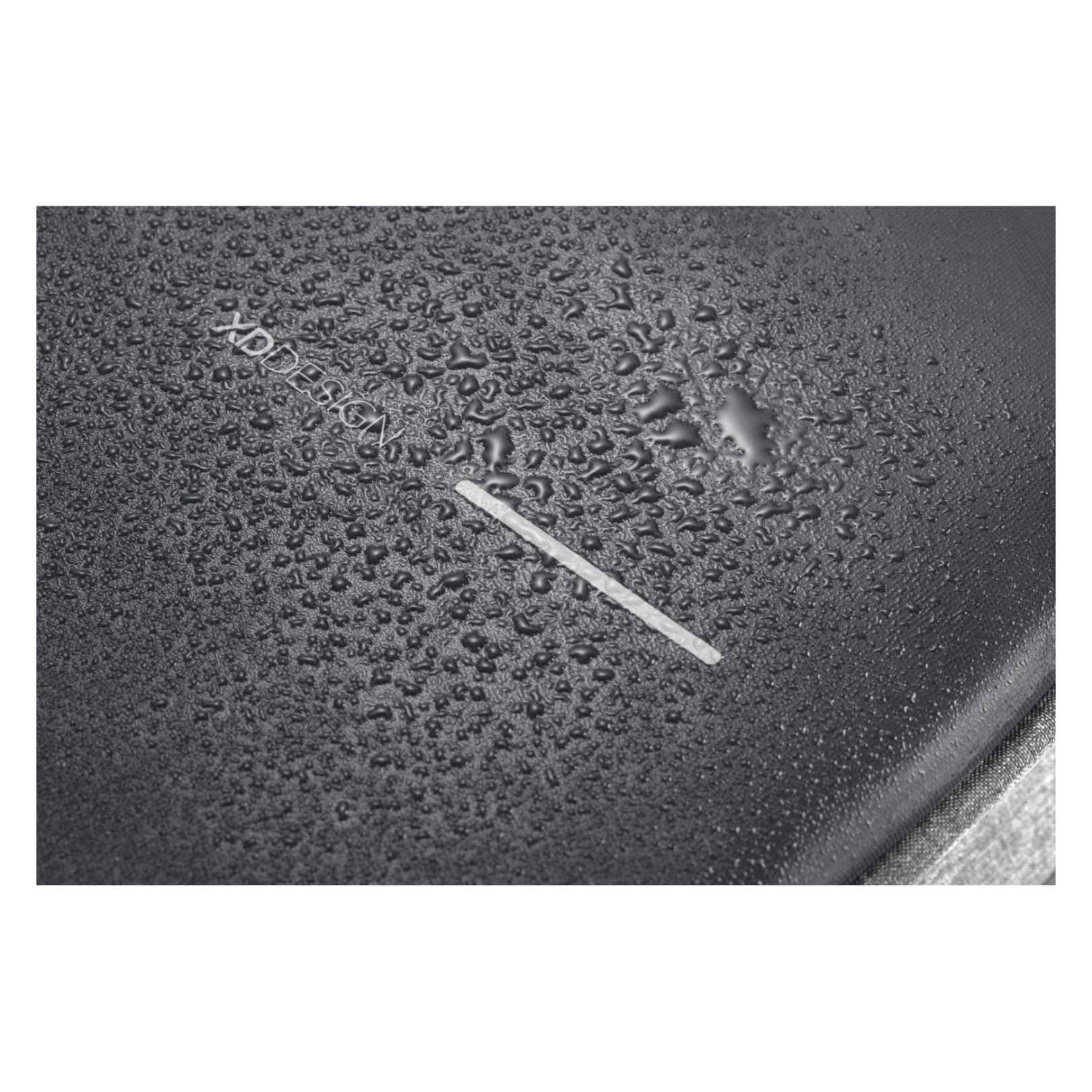Close-up of water droplets on the XD Design Bobby Pro Anti-Theft Backpack's waterproof fabric.