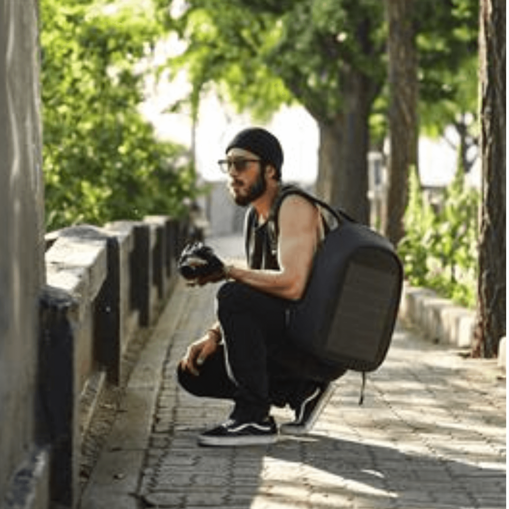 Man wearing XD Design Bobby Tech Anti-Theft Backpack, showcasing urban style and security features outdoors.